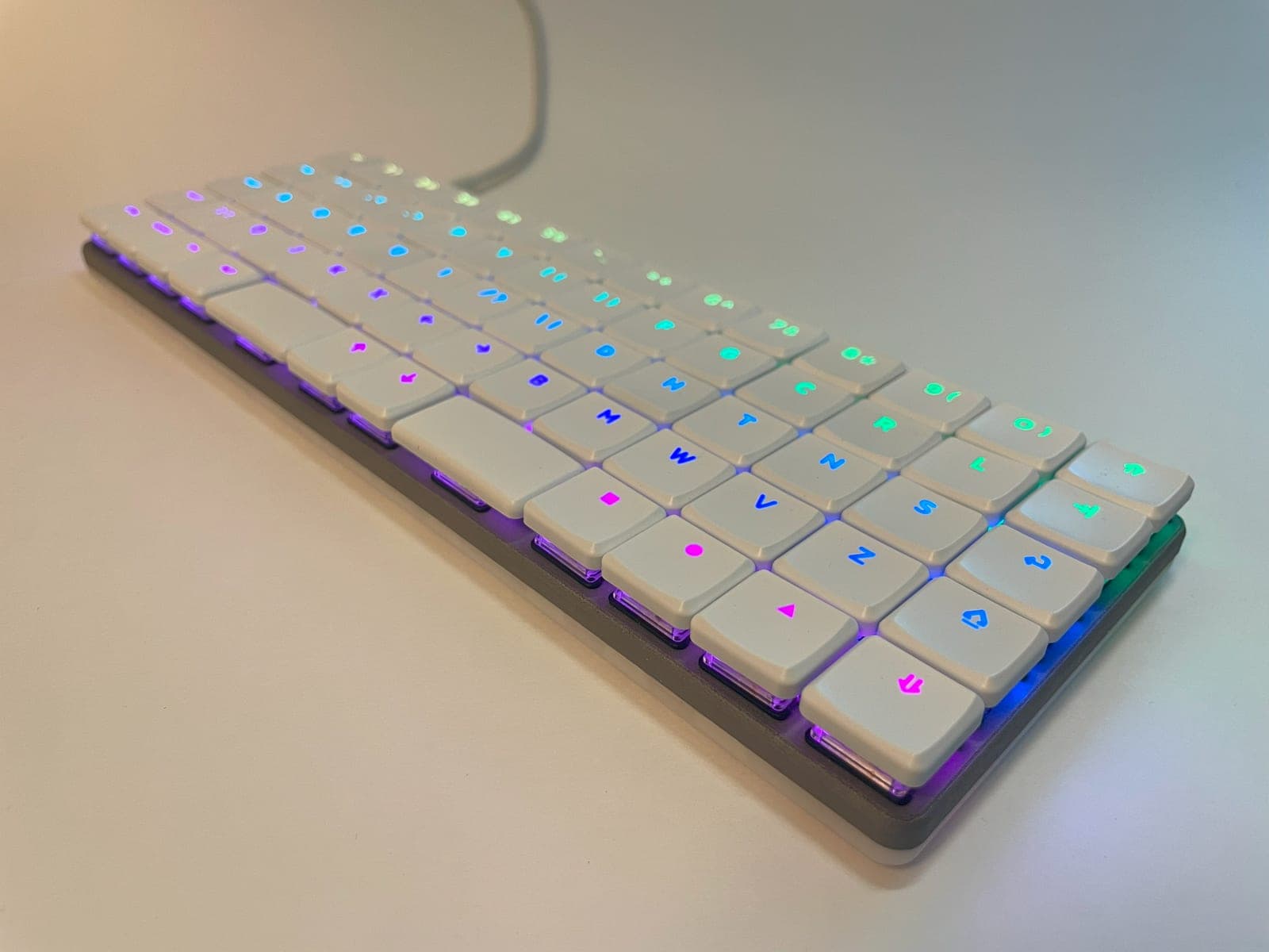 A KeBe keyboard at an angle with its per-key RGB lighting on.