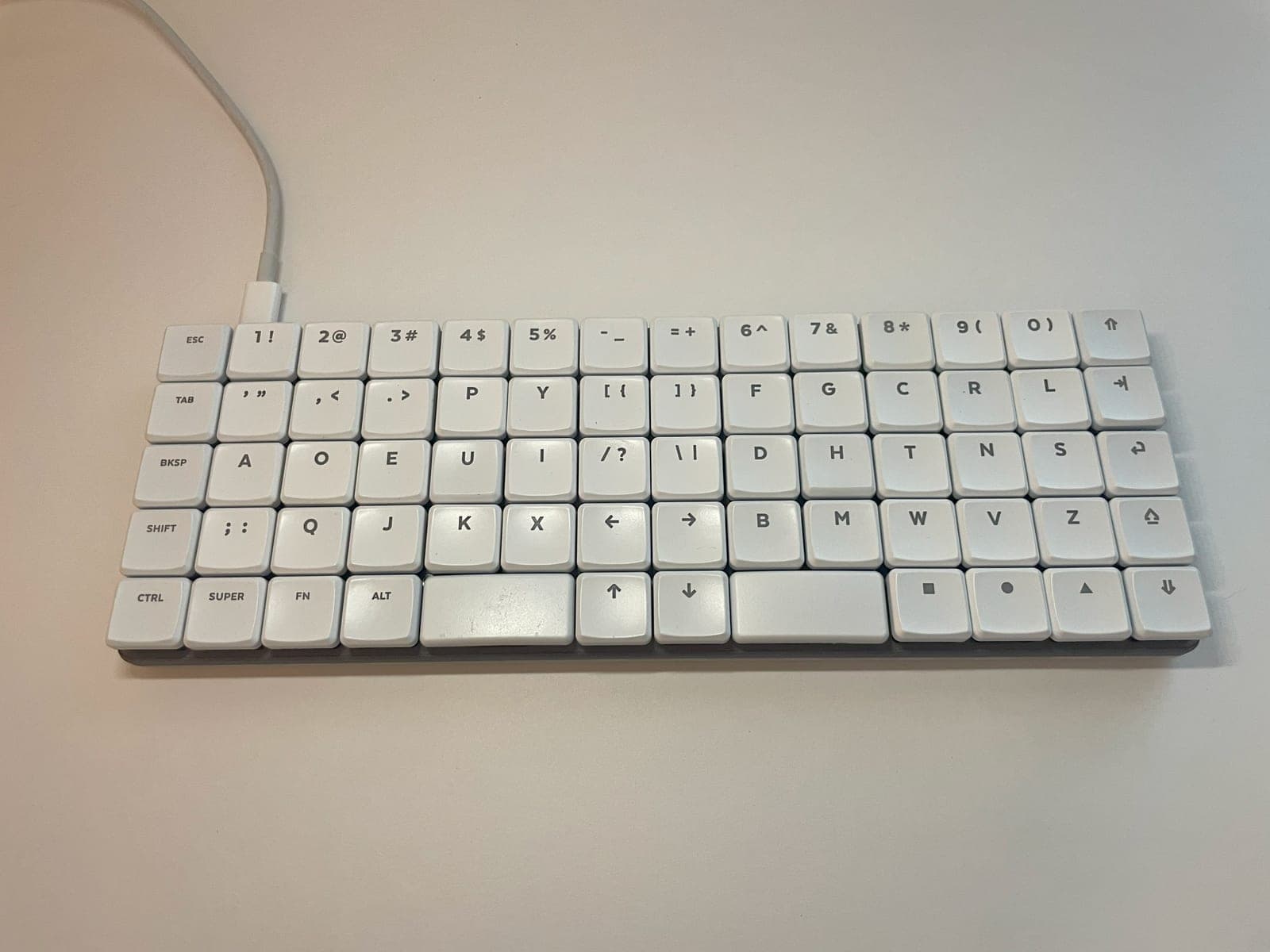 A KeBe keyboard seen straight on, its 68 keycaps laid out on a regular grid.